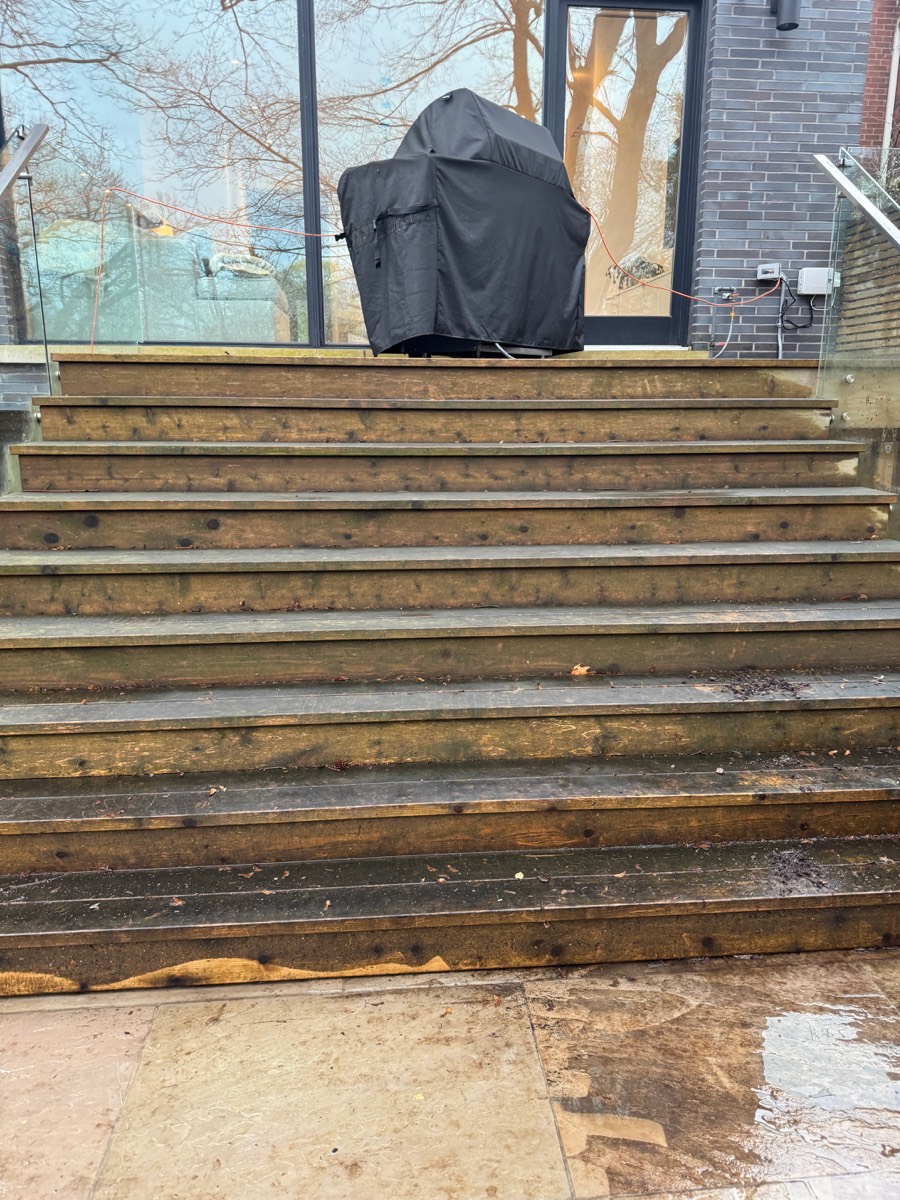 Dirty deck stairs covered in debris before cleanup