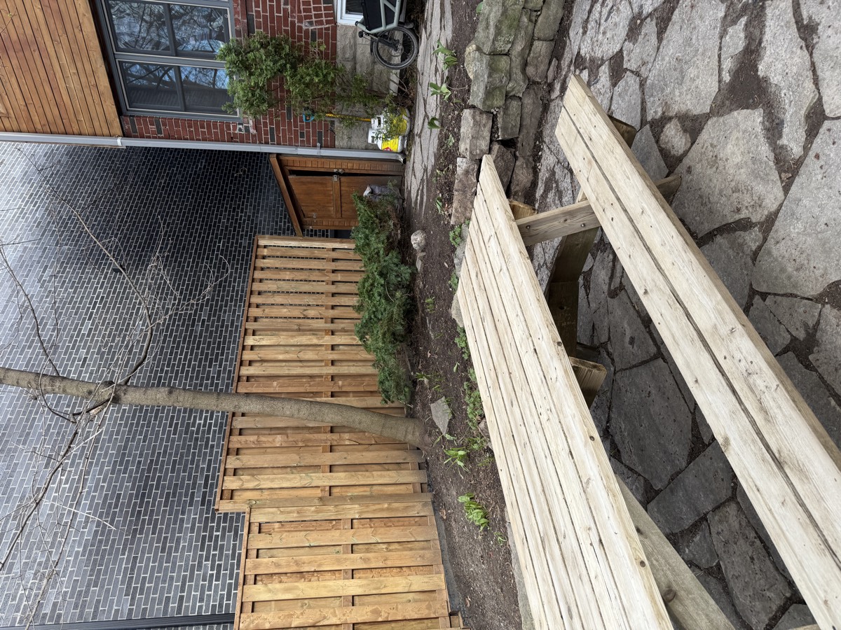 Clean front area with wood deck after spring cleanup